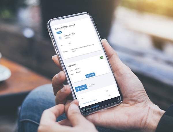 Hand holding mobile phone using JobLink by Formitize