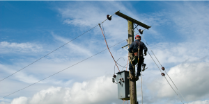 man climbing power pole