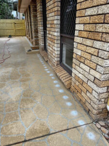 drill holes along the edge of a home