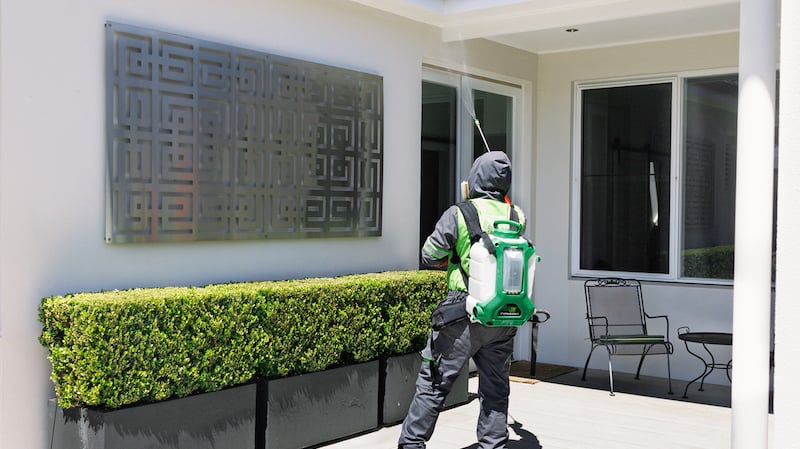 FlowZone Typhoon G3 spray unit being used to spray the exterior of a house