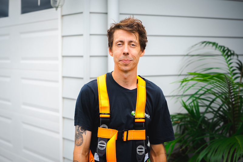 Shane Conzen from Affordable Pest Control in front of a house