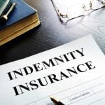 Document entitled indemnity insurance on a table