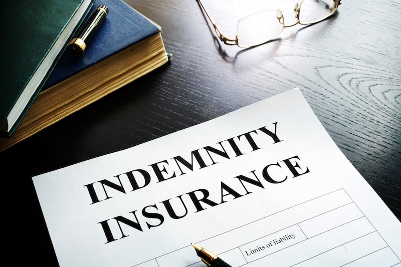 Document entitled indemnity insurance on a table