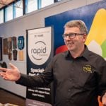 Ron Alexander, one of the Trainers at RapidTraining, wearing a black shirt presenting a class to students