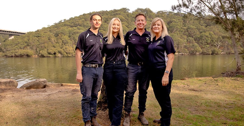 Drop Dead Pest Control team with a couple and their two children dressed in branded t-shirts